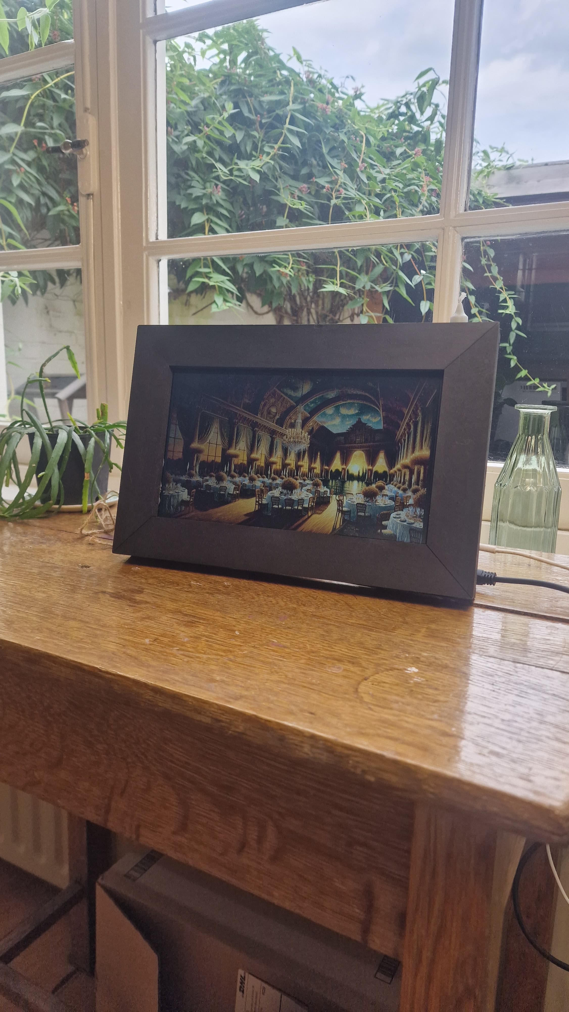A digital photo frame on a sideboard showing AI-generated artwork made from a week of photos